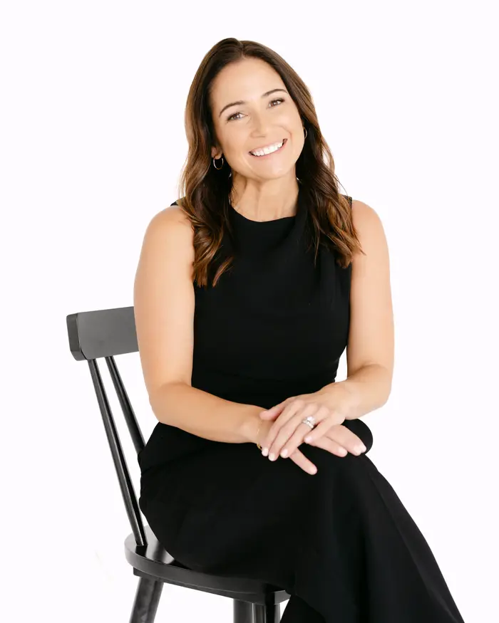 Holly Hepp, Founder and CEO, seated in a black dress