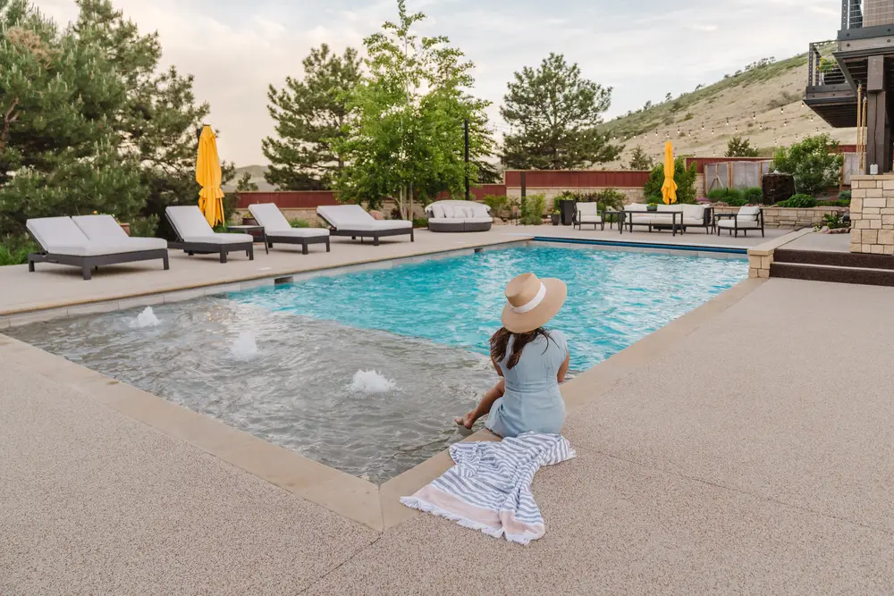 A woman in a white dress beside a resort pool
